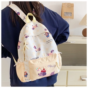 Close-up of canvas backpack featuring cute cartoon dog prints and multiple pocket details