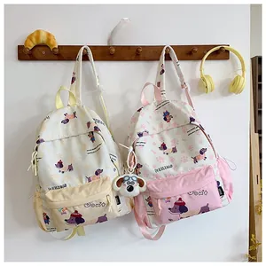 Detail of cute cartoon backpack with dachshund prints and plush dog charm pendant