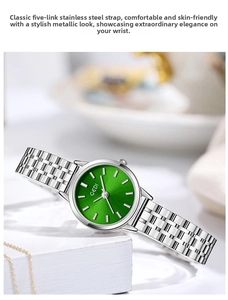 Close-up of a women's quartz watch with a green dial and silver Jubilee bracelet