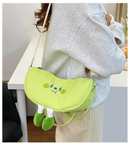 Detail of cute green crescent shoulder bag with cartoon embroidery and 3D feet