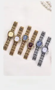 Detailed display of six luxury Gedi quartz watches with pearl dials and metal chain straps