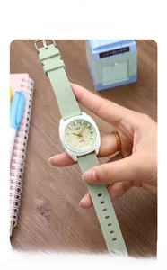 Close-up of mint green silicone quartz watch with embossed rhombus texture on a wrist