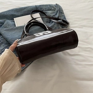 Vintage dark brown patent leather bowling bag with white number 99 print and top handle