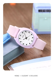 Close-up of GEDI women's quartz watch with pink silicone strap on a wooden surface