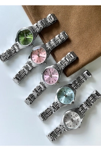 Detail shot of five quartz watch dial colors with elegant chain bracelets and metal texture