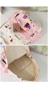 Detail view of pink cartoon dog print backpack with matching pouch and spacious interior