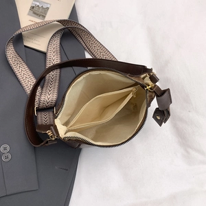 Dark brown bucket bag with wide wavy strap and interior zipper compartment