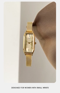 Detailopname van gouden rechthoekig quartzhorloge met mesh-band en kristallen accenten