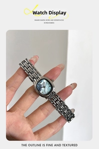 Detailed shot of silver steel bracelet watch with a blue mother of pearl square dial