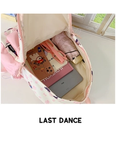 Top-down view of spacious pink student backpack interior with iPad and magazines