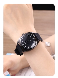Detail of GEDI black quartz watch with white square markers and silicone strap on wrist