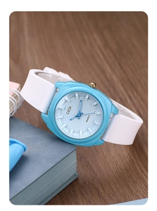 Blue minimalist quartz watch on desk with stationery highlighting modern casual aesthetics