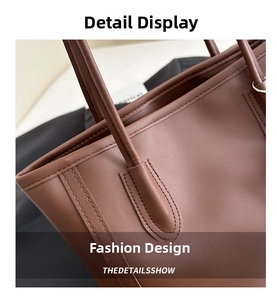 Detail of reinforced stitching and gold hardware on a vintage dark brown leather tote bag