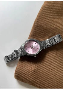 Detailed macro view of GEDI silver quartz watch with pink sunray dial on brown fabric