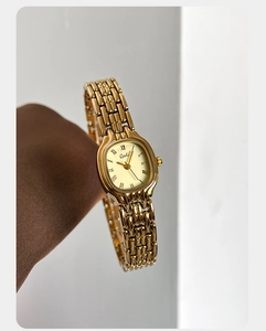 Close-up of Gedi luxury square quartz watch with gold chain strap and Roman numerals