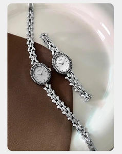 Detail of silver vintage quartz watches with oval dials and elegant chain bracelets