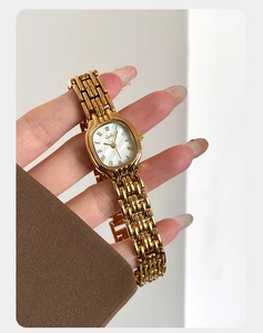 Detailed macro view of the gold Gekai quartz watch featuring Roman numeral indices