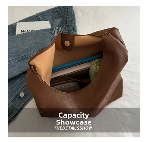 Brown lychee leather tote interior showing capacity for tablet, books, and umbrella