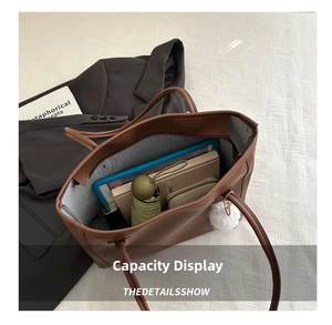 Top view of spacious brown leather tote bag interior showing capacity for daily essentials