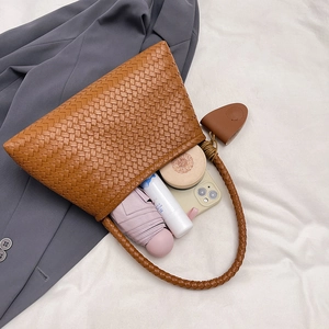 Large woven leather tote bag in brown featuring a spacious interior for daily essentials