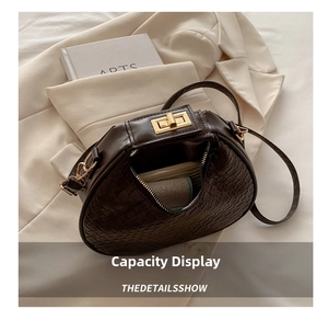 Internal capacity display of woven crescent bag with golden clasp and zipper