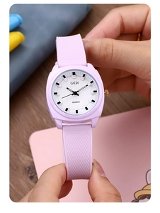 Detail of light purple quartz watch with diamond-patterned silicone strap and white dial