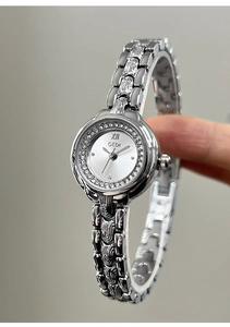 Detail of GEDI silver bracelet watch featuring rhinestone bezel and vintage floral texture