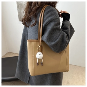 Chic beige large capacity tote bag shown with fluffy charm on grey wool coat