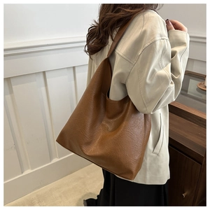 Close-up of caramel brown oversized tote bag with vintage textured leather finish