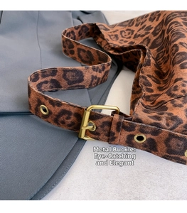 Detail of leopard print bag featuring adjustable gold metal buckle and soft velvet texture