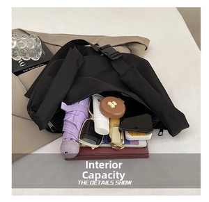 Detailed internal view showing large capacity for daily items in minimalist nylon crossbody bag