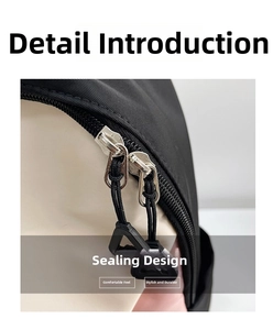 Detail of color-block backpack showing dual-way zippers and triangle pullers for durability