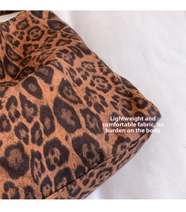 Close-up of soft leopard print suede texture and neat stitching on a large tote bag