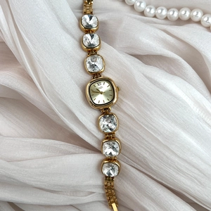 GEDI luxury women gold watch featuring large crystal bracelet and square dial on white silk