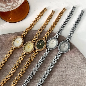Vintage small oval women's bracelet watches in gold and silver with textured dials