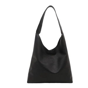 Minimalist black faux leather oversized tote bag with matte texture for winter commuting