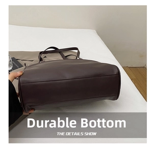 Detail view of the durable wear-resistant bottom on this coffee brown tote bag