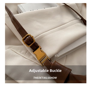 Detail of dark brown leather strap with adjustable gold buckle and quick-release clasp