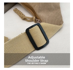 Detail of adjustable woven strap with buckle on a camel corduroy crossbody bag