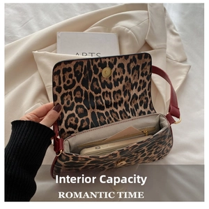 Internal view of leopard print bag showing zipper pocket and spacious capacity for phone