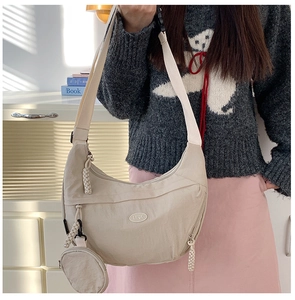 Beige nylon crescent hobo bag with adjustable strap and small detachable coin purse
