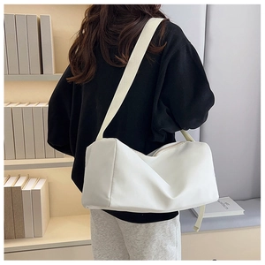 Détail de la vue arrière d'un sac bandoulière en nylon blanc épuré avec large bandoulière