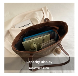 Detail shot of the large capacity interior of a brown tote bag with various daily essentials