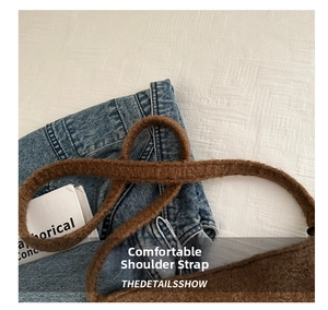 Close-up of comfortable brown faux shearling shoulder strap on wool tote bag