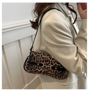 Detail of leopard print shoulder bag with gold horsebit buckle and leather trim