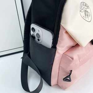 Three-color patchwork school backpack in black, pink and beige with side phone pocket