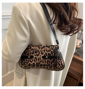 Detailed view of leopard print shoulder bag featuring vintage horsebit metal hardware buckle