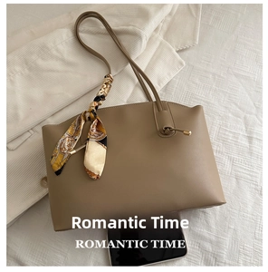 Detailed size comparison of khaki tote bag with silk scarf next to a smartphone