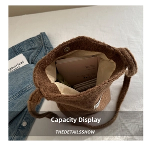 Internal view of the large brown wool bucket bag showing ample space and magnetic closure