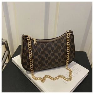 Detail of vintage brown crescent bag featuring metallic chain and all-over M-letter print